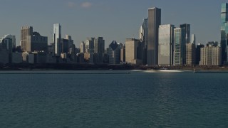 AX0169_0038 - 4K aerial stock footage of flying low toward Grant Park and towering skyscrapers, Downtown Chicago, Illinois