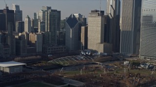 AX0169_0039 - 4K aerial stock footage ascend from lake to reveal iconic landmarks in Grant Park, Downtown Chicago, Illinois