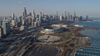 AX0169_0041 - 4K aerial stock footage approach Soldier Field, Field Museum, and the city's skyline, Downtown Chicago, Illinois