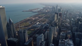 AX0169_0050 - 4K stock footage aerial video of passing the city's downtown skyscrapers to reveal and approach Grant Park, Downtown Chicago, Illinois