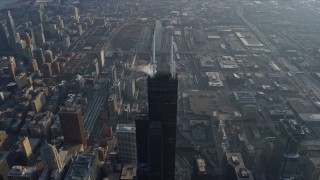 AX0169_0084 - 4K aerial stock footage fly toward the top of Willis Tower and tilt to a bird's eye view of the skyscraper, Downtown Chicago, Illinois