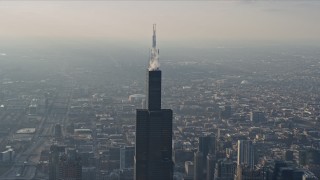 AX0169_0093 - 4K aerial stock footage of orbiting the top of Willis Tower, Downtown Chicago, Illinois