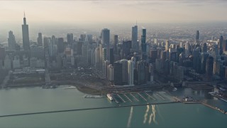 AX0169_0100 - 4K stock footage aerial video of flying past Downtown Chicago, Illinois, seen from Lake Michigan