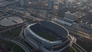 AX0169_0101 - 4K aerial stock footage approach Soldier Field and tilt to a bird's eye view of the field, Chicago, Illinois