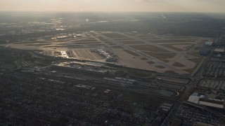 AX0169_0105 - 4K aerial stock footage of approaching Chicago Midway International Airport at sunset, Illinois