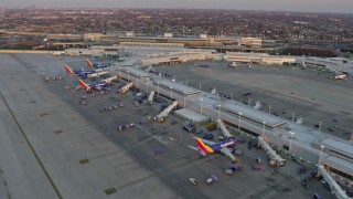 AX0170_0001 - 4K stock footage aerial video of Southwest jets at Chicago Midway International Airport at sunset, Illinois