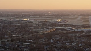AX0170_0003 - 4K aerial stock footage of flying away from Chicago Midway International Airport at sunset, Illinois