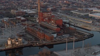 AX0170_0008 - 4K aerial stock footage of the Fisk Generating Station at sunset, West Side Chicago, Illinois