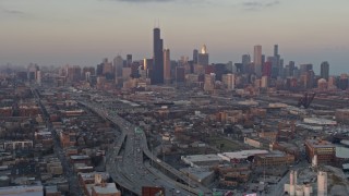 AX0170_0009 - 4K aerial stock footage wide view of the Downtown Chicago skyline seen from South Side Chicago at sunset, Illinois