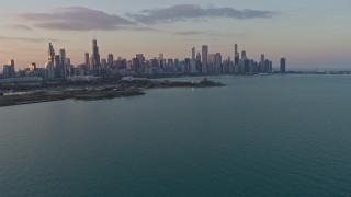 AX0170_0012 - 4K stock footage aerial video of the Downtown Chicago skyline, seen from Lake Michigan at sunset, Illinois