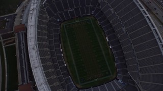 AX0170_0038 - 4K aerial stock footage of a bird's eye view of Soldier Field football stadium at sunset, Chicago, Illinois