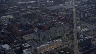AX0170_0045 - 4K aerial stock footage of flying by a hospital on the West Side at sunset, Chicago, Illinois