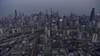 AX0170_0046 - 4K aerial stock footage of flying high toward skyscrapers in downtown at sunset, Downtown Chicago, Illinois