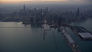 AX0170_0049 - 4K stock footage aerial video of approaching Downtown Chicago skyscrapers, Chicago River, and Navy Pier at sunset, Chicago, Illinois