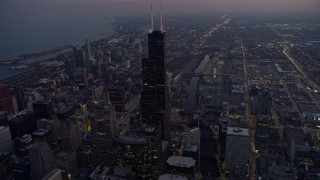 AX0170_0051 - 4K aerial stock footage of flying past Willis Tower and  311 South Wacker Drive at sunset, Downtown Chicago, Illinois
