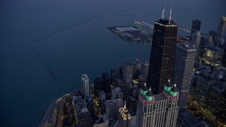 AX0170_0054 - 4K aerial stock footage orbit John Hancock Center with holiday lights at twilight, Downtown Chicago, Illinois