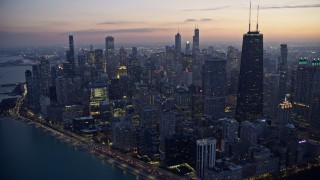 AX0170_0055 - 4K aerial stock footage of John Hancock Center with holiday lights at twilight, Downtown Chicago, Illinois