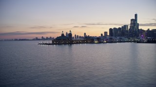 AX0170_0057 - 4K stock footage aerial video fly low around Navy Pier, reveal waterfront skyscrapers at twilight, Downtown Chicago, Illinois