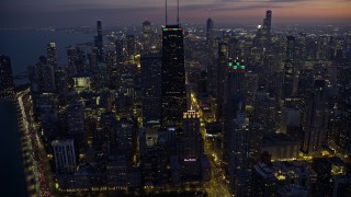 AX0170_0059 - 4K aerial stock footage of John Hancock Center and 900 North Michigan with holiday lights at twilight, Downtown Chicago, Illinois