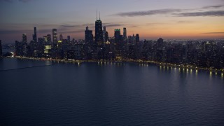 AX0170_0061 - 4K aerial stock footage of John Hancock Center and lakeside skyscrapers seen from Lake Michigan at twilight, Downtown Chicago, Illinois