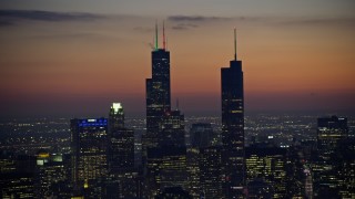 AX0170_0064 - 4K aerial stock footage of Willis Tower and Trump Tower with holiday lights at twilight, Downtown Chicago, Illinois