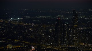AX0170_0069 - 4K aerial stock footage of a baseball stadium lit up at night in West Side Chicago, Illinois