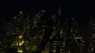 AX0170_0076 - 4K aerial stock footage of approaching the St. Regis Chicago, with a view of Navy Pier, at night, Downtown Chicago, Illinois