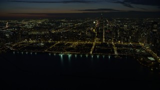 AX0170_0078 - 4K aerial stock footage of a wide view of Grant Park and downtown skyscrapers, some with holiday lights at night, Downtown Chicago, Illinois
