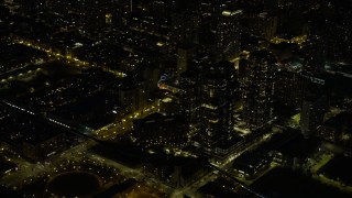 AX0170_0082 - 4K aerial stock footage of apartment buildings at night, Downtown Chicago, Illinois