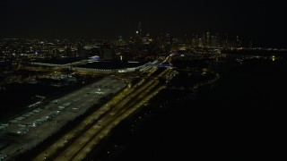 AX0170_0086 - 4K aerial stock footage the downtown skyline seen from McCormick Place and State Route 41 at night, Downtown Chicago, Illinois