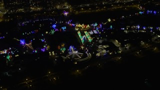 AX0170_0089 - 4K stock footage aerial video approach and flyby Lincoln Park Zoo, lit with holiday lights at night, Chicago, Illinois