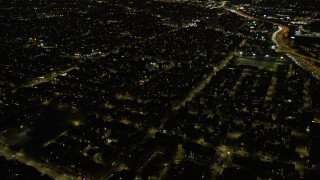 AX0170_0102 - 4K aerial stock footage of flying over urban neighborhoods on the West Side at night, Chicago, Illinois