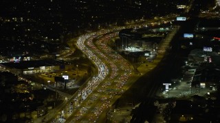 AX0170_0105 - 4K aerial stock footage of heavy traffic on the Kennedy Expressway on the Northwest Side at night, Chicago, Illinois