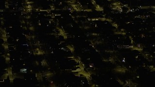 AX0170_0109 - 4K aerial stock footage tilt to homes with holiday decorations on the Northwest Side at night, Chicago, Illinois