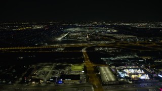 AX0170_0111 - 4K aerial stock footage of approaching O'Hare International Airport at night, Chicago, Illinois