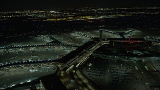 AX0170_0112 - 4K stock footage aerial video approach and flyby the terminals at O'Hare International Airport at night, Chicago, Illinois