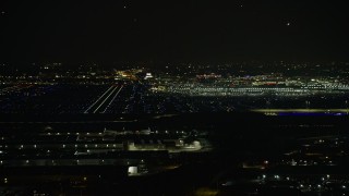 AX0170_0115 - 4K aerial stock footage a wide view of the runways and terminals at O'Hare International Airport at night, Chicago, Illinois