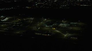 AX0170_0126 - 4K aerial stock footage of Stateville Correctional Center prison at night, Crest Hill, Illinois