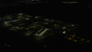AX0170_0128 - 4K aerial stock footage of orbiting Stateville Correctional Center prison at night, Crest Hill, Illinois