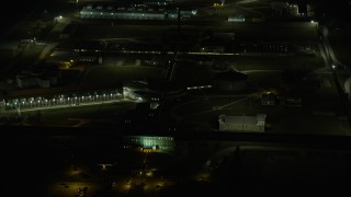 AX0170_0129 - 4K aerial stock footage of circling Stateville Correctional Center prison at night, Crest Hill, Illinois