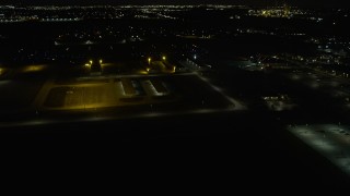 AX0170_0133 - 4K aerial stock footage of flying toward Lewis University Airport at night, Romeoville, Illinois
