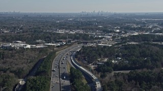 AX0171_0002 - 6.7K aerial stock footage tilt from Interstate 75 to reveal the distant Atlanta skyline, Marietta, Georgia