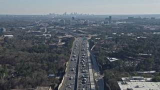 AX0171_0004 - 6.7K aerial stock footage tilt from heavy I-75 traffic to reveal a wide view of the distant Atlanta skyline, Marietta, Georgia