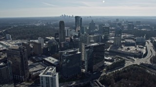 AX0171_0027 - 6.7K aerial stock footage of Buckhead office buildings and skyscrapers, Atlanta skyline visible in distance, Georgia