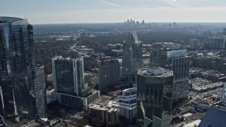 AX0171_0028 - 6.7K aerial stock footage of Buckhead office buildings with Atlanta skyline visible in distance, Georgia