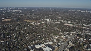 AX0171_0045 - 6.7K aerial stock footage of approaching homes, a high school and football field in Atlanta, Georgia