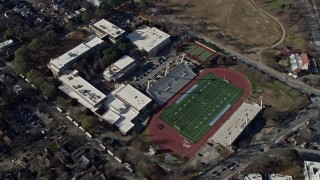 AX0171_0046 - 6.7K stock footage aerial video of flying by a high school and football field in Atlanta, Georgia