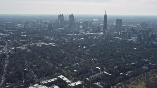 AX0171_0047 - 6.7K aerial stock footage tilt from high school to reveal skyscrapers in Midtown Atlanta, Georgia