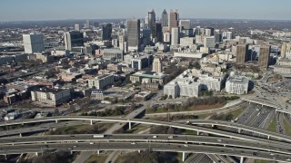 AX0171_0073 - 6.7K aerial stock footage tilt from freeway interchange to reveal Downtown Atlanta skyscrapers, Georgia