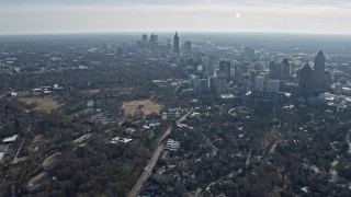 AX0171_0097 - 6.7K aerial stock footage of tilting from residential neighborhood to reveal Midtown and Downtown Atlanta, Georgia